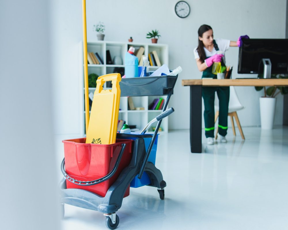 YOUNG FEMALE JANITOR CLEANING OFFICE WITH VARIOUS CLEANING EQUIPMENT - THOGA SPARKLE SOLUTIONS BALI